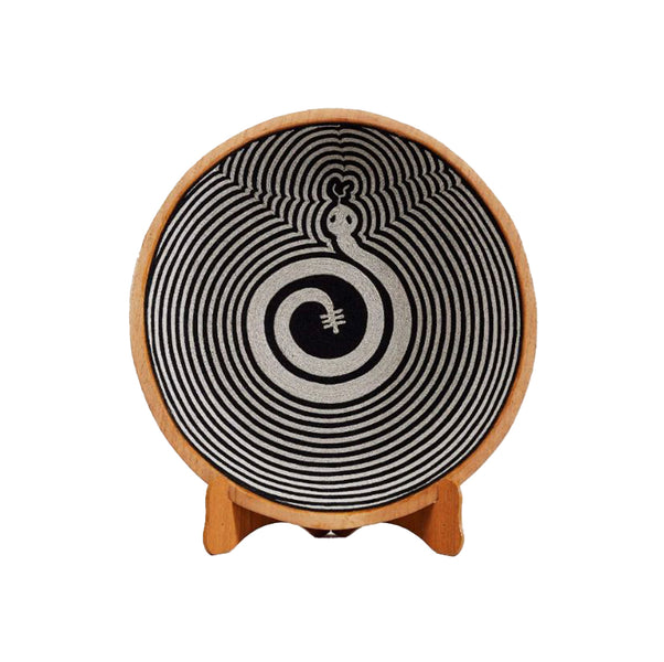 Snake Spiral Plate featuring intricate black and white design, inspired by huichol yarn bowl craftsmanship.